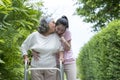 Happy Asian senior woman physical therapy by walker, she Kiss Asian female physical therapist nurse support and take care her Royalty Free Stock Photo