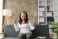 Happy Asian senior woman holding mobile phone for online video call Sitting on the sofa, Royalty Free Stock Photo