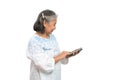 Happy Asian senior woman holding smartphone and using online apps in mobile phone and texting sms message chatting on isolated Royalty Free Stock Photo