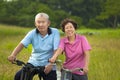 Happy Asian seniors couple biking in Park. Royalty Free Stock Photo