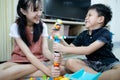 Happy asian sister and smiling little brother playing with colorful toys together at home,kindergarten kid boy and child girl Royalty Free Stock Photo