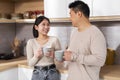 Happy asian spouses enjoying time together, drinking coffee Royalty Free Stock Photo