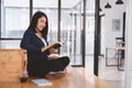 Happy asian student girl reading a book alone at library Royalty Free Stock Photo