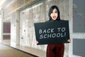 Happy asian student woman with board with back to school text Royalty Free Stock Photo