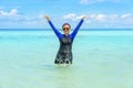 Happy asian teen girl play splashing water in the sea Royalty Free Stock Photo