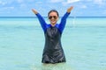 Happy asian teen girl play splashing water in the sea Royalty Free Stock Photo