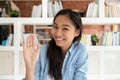 Happy asian teen girl student making video call to friend Royalty Free Stock Photo