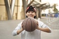 Happy asian teenage basketball player