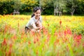 Happy asian teenager girl touching flower zinnia and taking care of plants in beautiful garden in summer,smiling child girl play