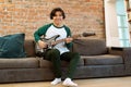 Happy Asian Teenager Guy With Electric Guitar Posing At Home