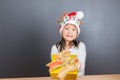 Happy asian thai child girl with Christmas gifts near a Christm Royalty Free Stock Photo