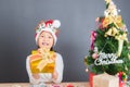 Happy asian thai child girl with Christmas gifts near a Christm Royalty Free Stock Photo