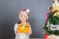 Happy asian thai child girl with Christmas gifts near a Christm Royalty Free Stock Photo