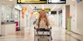 Happy asian tourist woman with backpack and luggage traveling between waits for flight in airport terminal, Tourist Royalty Free Stock Photo
