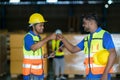 Happy Asian warehouse workers having fun and fist bumping during beginning start work in morning