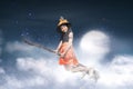 Happy asian witch girl flying on broomstick