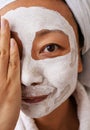 Young asian Woman With Cleansing Mask On Her Face At Home. Skin Care. Royalty Free Stock Photo