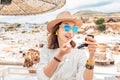 Asian woman applying Makeup outdoors. Girl using pocket mirror and lipstick Royalty Free Stock Photo