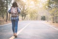 Happy Asian woman backpack in the road and forest background