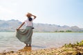 Happy asian woman in casual style clothing standing in the river with mountain view Royalty Free Stock Photo