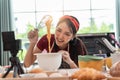 Happy asian woman is cooking cookies and having fun in the kitchen. She making video for her culinary vlog Royalty Free Stock Photo