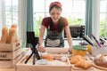 Happy asian woman is cooking cookies and having fun in the kitchen. She making video for her culinary vlog Royalty Free Stock Photo