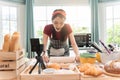 Happy asian woman is cooking cookies and having fun in the kitchen. She making video for her culinary vlog Royalty Free Stock Photo