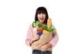 Happy Asian woman with credit card holding paper bag full of fresh vegetable groceries isolated on white background Royalty Free Stock Photo