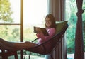 Happy asian woman drinking coffee and reading book in living room,Morning time,Relax and fresh