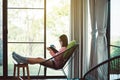 Happy asian woman drinking coffee and reading book in living room,Morning time,Relax and fresh