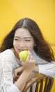 Happy asian woman eatting green apple Royalty Free Stock Photo