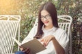 Happy asian woman enjoy reading outdoor Royalty Free Stock Photo