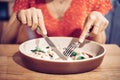 Asian woman enthusiastically eats a delicious dish in a Haute cuisine restaurant