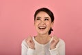 Happy asian woman feeling excited on accomplish success on pink background, Portrait of smiling winner girl