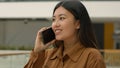 Happy Asian woman girl talk mobile phone in office chinese japanese businesswoman talking cellphone conversation Royalty Free Stock Photo