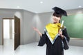 Happy asian woman with graduation cap and diploma scroll Royalty Free Stock Photo