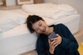 Happy asian woman hand using smartphone typing, chatting conversation in chat box on her bedroom, Social media maketing Royalty Free Stock Photo