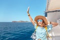 asian woman in hat enjoying travel and vacation on Cruise ship. Tourist girl on the deck Royalty Free Stock Photo