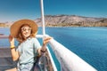 Asian woman in hat enjoying travel and vacation on Cruise ship. Tourist girl on the deck Royalty Free Stock Photo