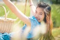 Happy Asian woman having relax time on a swing in nature field for nature hapiness lifestyle