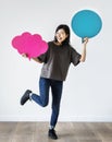 Happy Asian woman holding copyspace speech bubble Royalty Free Stock Photo