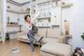 Happy asian woman holding with mop cleaning floor and singing at home. Housekeeping concept Royalty Free Stock Photo
