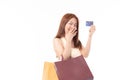 Happy Asian woman holding shopping bags and showing credit card. Beautiful charming woman with many shopping bags brand name Royalty Free Stock Photo