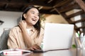 Happy asian woman laughing, working on laptop from home. Girl student studying on computer, online learning, remote Royalty Free Stock Photo