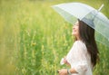 Happy asian woman lifestyle hand holding umbrella in the meadow yellow flower sunrise. Active Outdoor Relax and enjoy in Nature