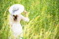 Happy asian woman lifestyle in the meadow yellow flower sunrise. Active Outdoor Relax and enjoy in Nature. Royalty Free Stock Photo