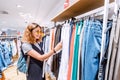 Asian woman looking for jeans in clothes store. Shopping and lifestyle concept Royalty Free Stock Photo