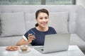 Happy asian woman lying on the floor carpet and shopping online with credit card and laptop at home. Online shopping, technology, Royalty Free Stock Photo