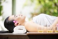 Happy asian woman lying on massage table Royalty Free Stock Photo