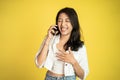 happy asian woman making a call using a cell phone Royalty Free Stock Photo